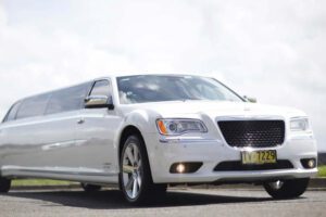 Chrysler 300C Super Stretch white limousine on the road