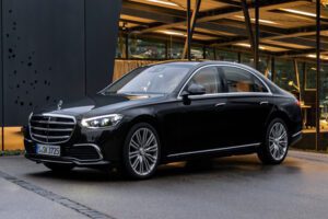Elegant black Mercedes-Benz S-Class parked in front of a modern building