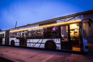 Party bus with neon lights parked at night