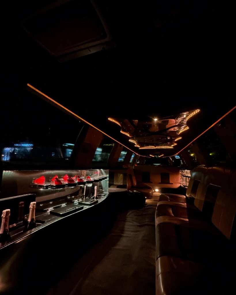 Luxurious limousine interior with leather seats and champagne bottles