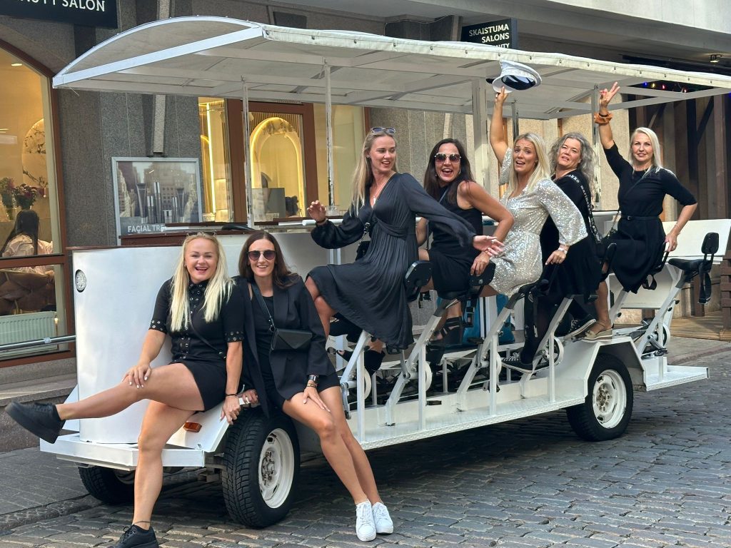 Women dressed up in black celebrating on a Prosecco Bike in Riga