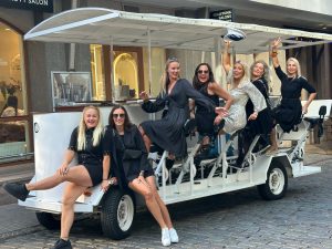 Women dressed up in black celebrating on a Prosecco Bike in Riga