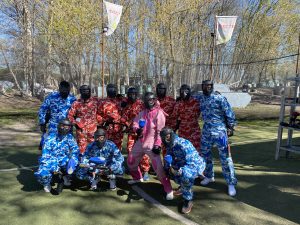 Paintball team posing in colorful camouflage suits before the game