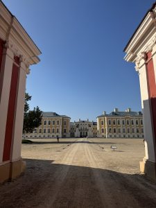 View of Rundale Palace through the entrance gates under a clear blue sky