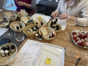 Perfume ingredients and wine glasses on a workshop table