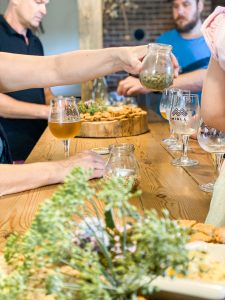 Table with craft beer glasses, hops, grains, and Latvian snacks