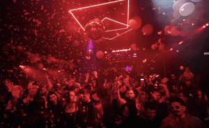 Crowded dance floor with confetti and disco lights