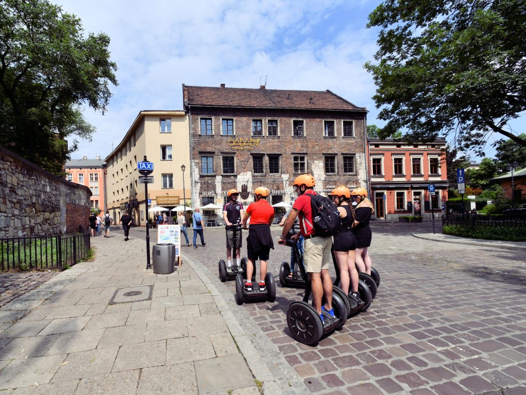Segway group riding through a historic square in Krakow's Jewish Quarter