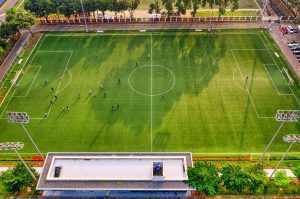 Aerial view of a standard football pitch with players