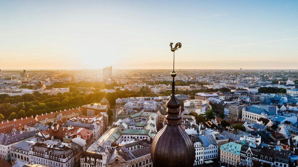 Aerial view of Riga at sunset with the rooster weather vane in the foreground