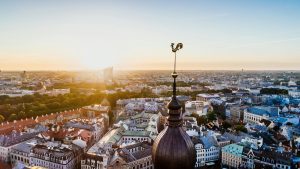 Aerial view of Riga at sunset with the rooster weather vane in the foreground