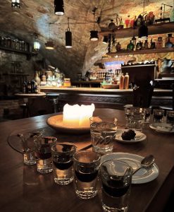 Candlelit table with traditional Latvian shots and snacks